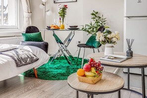 Relax in a serene space with a comfortable bed, a cozy reading nook, and a stylish seating area.