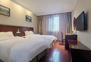 A hotel room with two beds, a desk, a chair, a flat-screen TV, and a window with curtains. - Greentree Inn Suzhou Wuzhong District Fengjin Road Business Hotel (Suzhou)