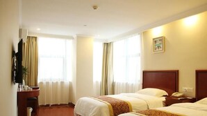 A hotel room with two beds, a desk, a chair, a TV, and a window with curtains. - Greentree Inn Suzhou Fengjin Road Business Hotel (Suzhou)
