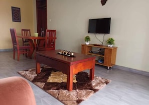 Apartment | Living area | 28-inch flat-screen TV with digital channels - NL JOSEPHINES APARTMENTS (Kampala)