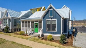 A row of modern, single-story houses with gabled roofs and front porches. - Dog Friendly Home in Carlton Landing | Blue Haven (Carlton Landing,)