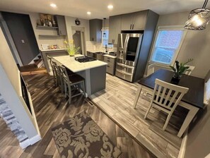 Enjoy cooking and dining in this well-equipped kitchen with a central island, gas stove, and seating for four.