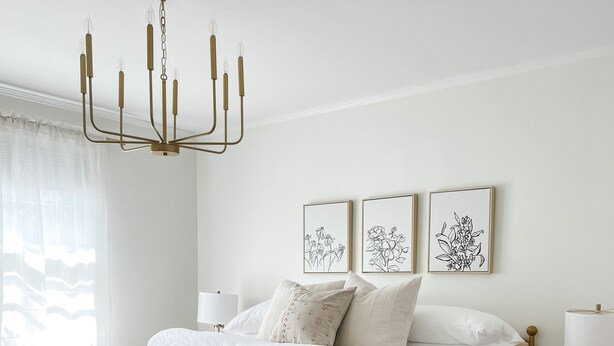 A bedroom with a large bed, a chandelier, bedside tables, and wall art. - High Point Corner - Best Location! (Memphis)