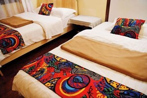 Two single beds with colorful headboards and white bedding. - Maple Leaf Inn Lijiang (Lijiang)