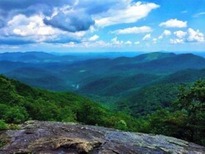 Surrounded by rolling hills and a clear sky, this serene landscape offers a peaceful escape.