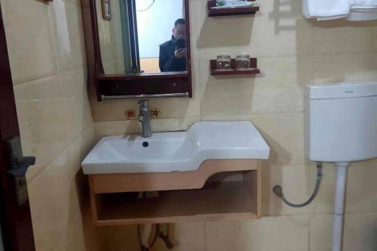 A bathroom with a sink, mirror, and toilet.