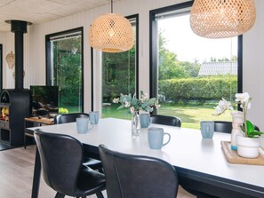 A dining area with a table, chairs, and a view of the outdoors. - 6 Person Holiday Home in Tarm (Tarm)