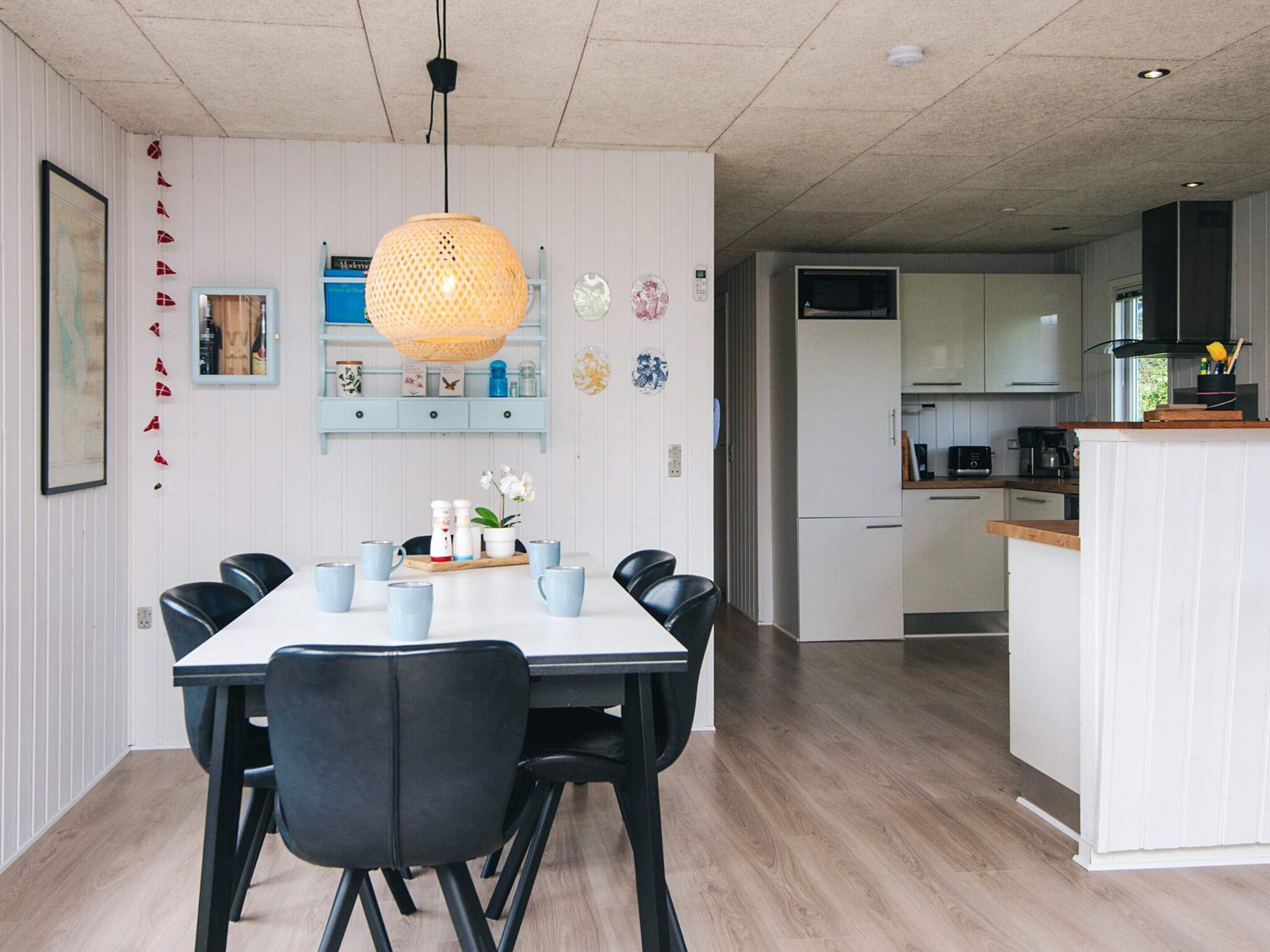 A modern kitchen with white cabinets, a microwave, and a coffee maker.