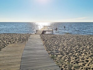 A wooden pier leading to a beach with clear skies. - 6 Person Holiday Home in Tarm (Tarm)