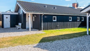 A single-story building with a dark exterior, a sloped roof, and a small porch area. - 6 Person Holiday Home in Ebeltoft (Ebeltoft)
