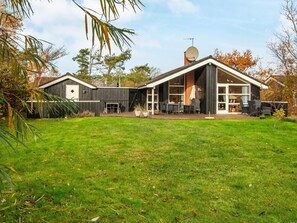 A modern house with a large backyard, a satellite dish, and a covered patio area. - 4 Star Holiday Home in Ebeltoft (Ebeltoft)
