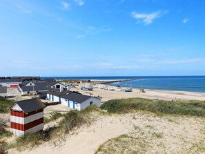 A coastal area with buildings, boats, and a sandy beach. - 10 Person Holiday Home in Thisted (Thisted)