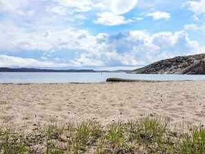 A sandy beach with a clear sky and distant hills. - 4 Person Holiday Home in Lysekil (Lysekil)