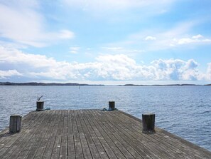 A wooden pier extending into calm water with a clear sky above. - 4 Person Holiday Home in Lysekil (Lysekil)