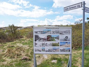 A signboard with historical photos and text, set against a natural landscape. - 4 Person Holiday Home in Lysekil (Lysekil)