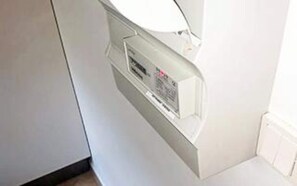 A white electrical panel with a control interface, located in a corner of a room with white walls. - 4 Star Holiday Home in Skagen (Skagen)