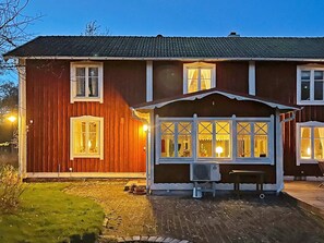 A two-story wooden house with a covered porch and multiple windows. - 9 Person Holiday Home in Ronneby (Listerby)