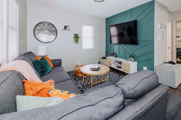 Cozy living room with a 65" Smart TV. Sign in to any of your favorite streaming services or watch the free channels on the TV!