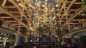 A multi-level atrium with a central staircase, surrounded by bookshelves and seating areas.