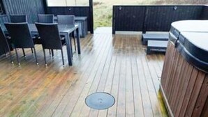 A wooden deck with outdoor seating and a hot tub. - 4 Star Holiday Home in Hjorring (Hjørring)