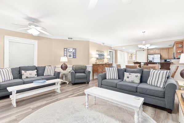 Relax in this stylish living room with a grey sofa, coffee table, and bench.