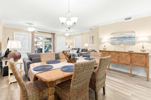 Enjoy meals in this stylish dining area with a wooden table and wicker chairs.