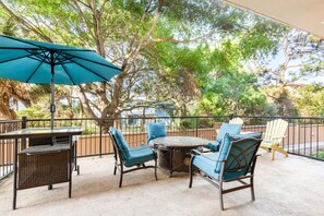 Relax with a meal or drink at this outdoor patio, featuring a round table and four comfortable chairs.