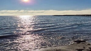 A beach with a pier extending into the water, under a clear sky. - 4 Star Holiday Home in Hejls (Hejls)