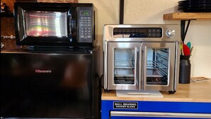 A kitchen with a Hisense microwave, a silver oven, and a blue ball bearing drawer slide unit. - The Artists Cottage ~ Fun desert getaway (Ajo)
