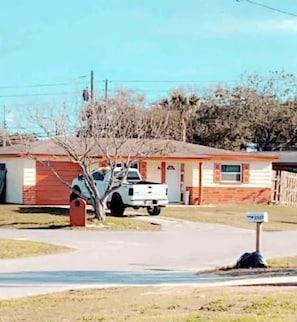 A single-story house with a red brick exterior and a white garage door. - Holiday home with private heated pool available . for extra $20 for each night
 (Holiday)