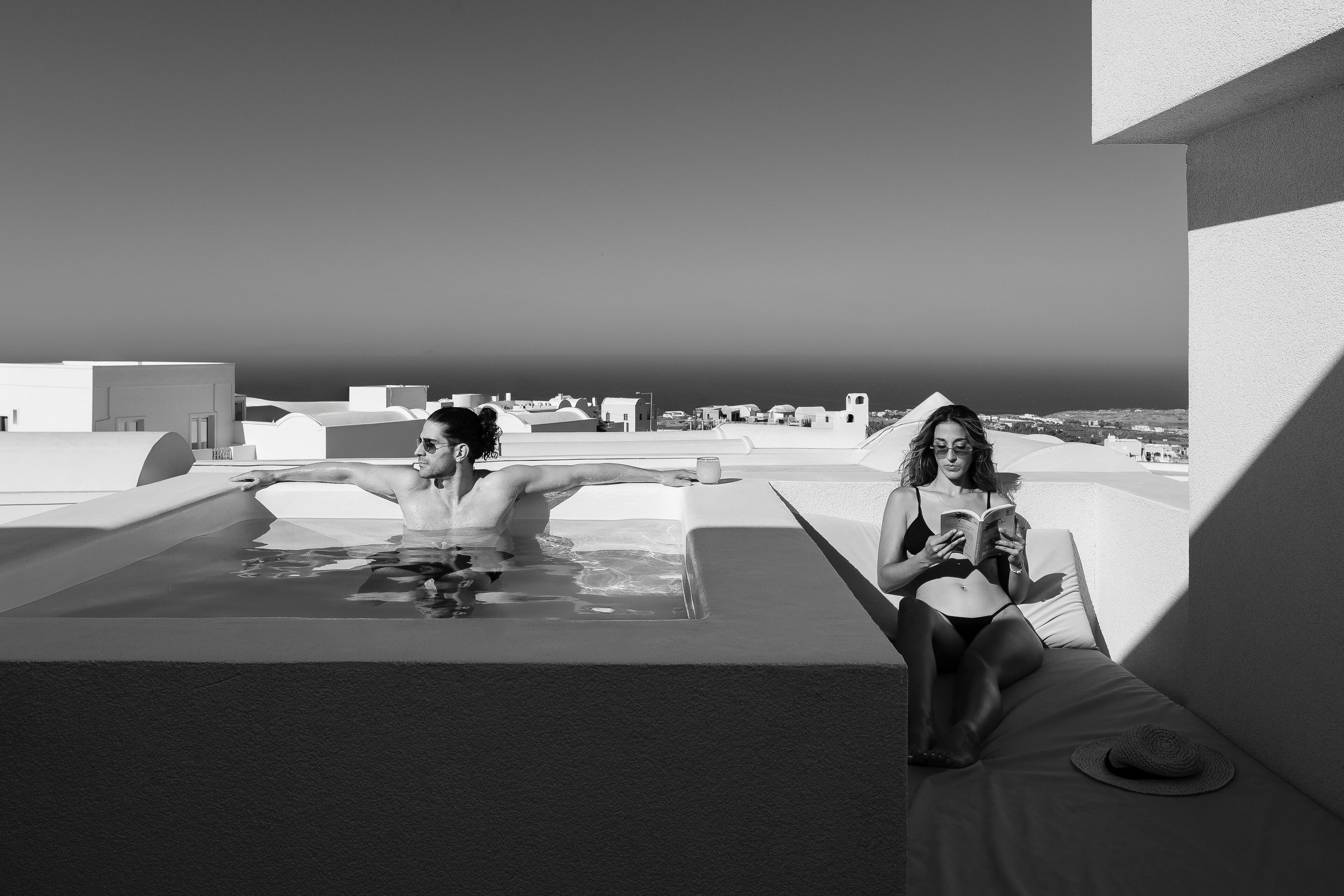 A modern rooftop pool area with a clear view of the cityscape.