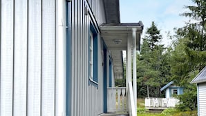 A two-story house with a porch and a small front yard. - 6 Person Holiday Home in Trollhattan (Trollhattan)