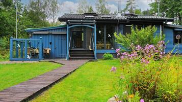 Traditional building with a welcoming entrance, surrounded by lush gardens and greenery.