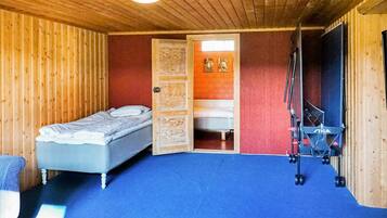 A room with a bed, a desk with a chair, and a window.