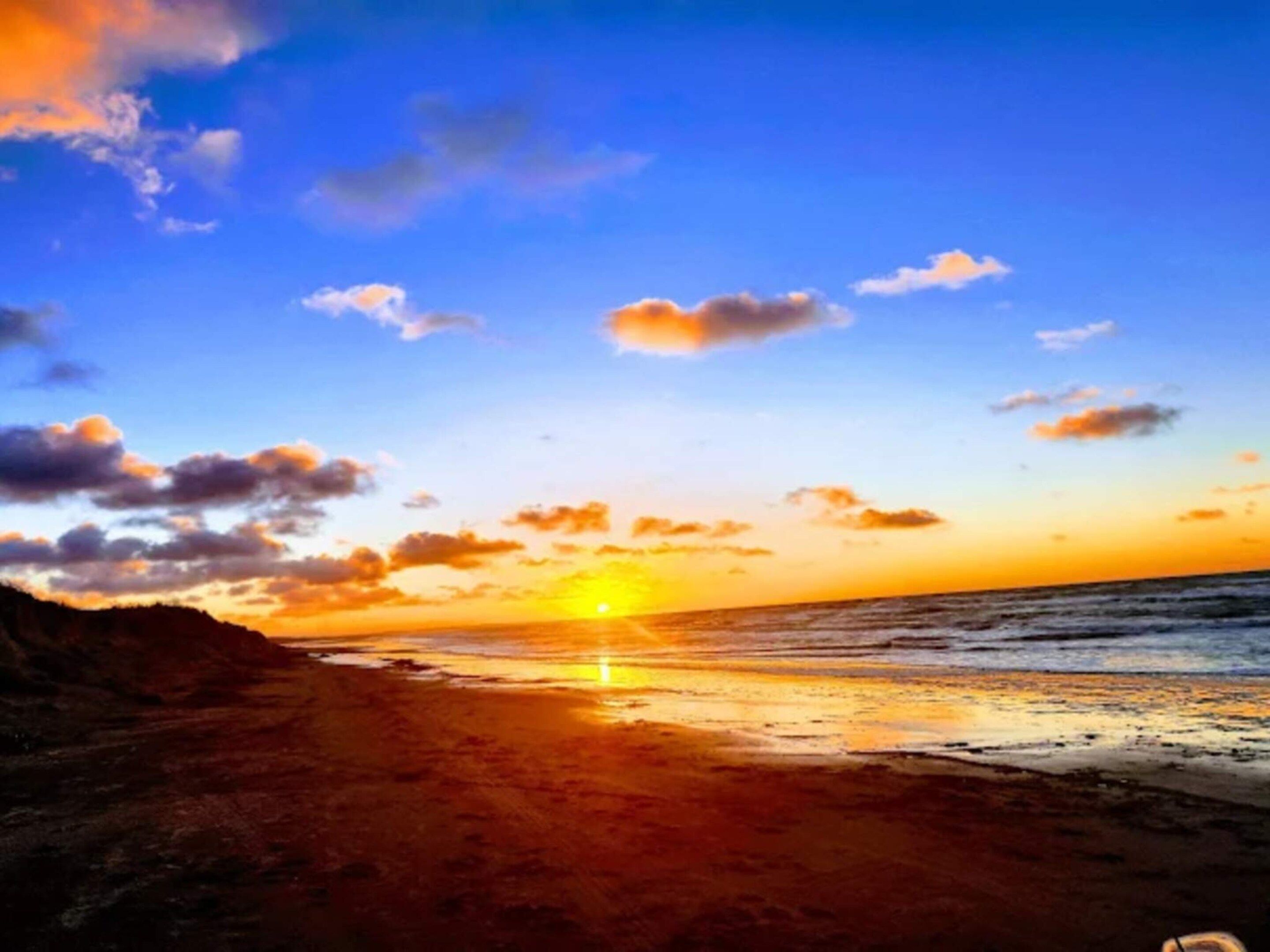 A beach with a sunset.