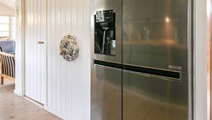 A stainless steel refrigerator with a water dispenser, a wooden door, and a decorative wreath. - 6 Person Holiday Home in Jerup (Jerup)