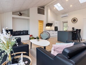A modern interior with a living area, kitchen, and dining space. - 5 Star Holiday Home in Saltum (Saltum)