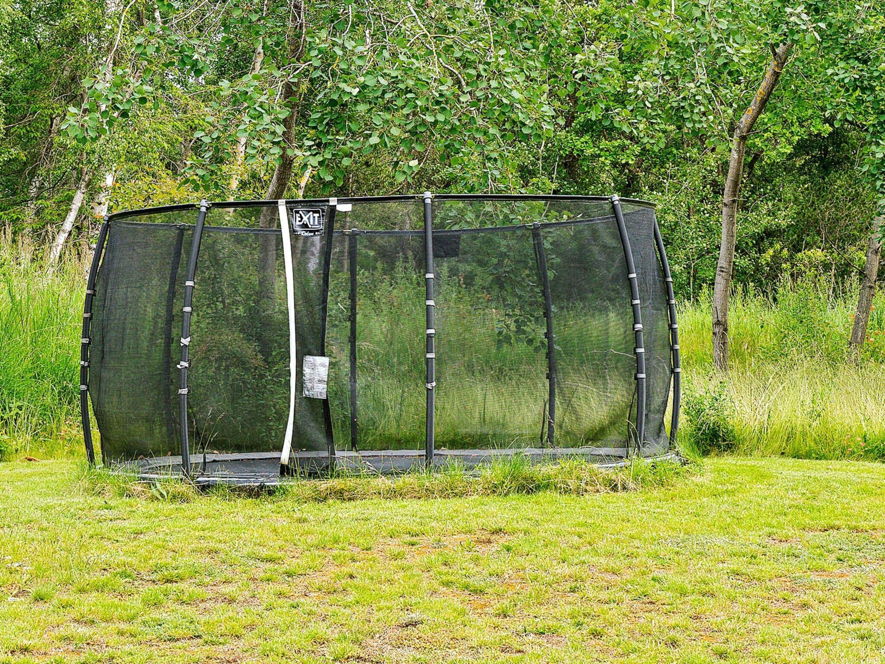A fenced enclosure with a sign indicating an exit.