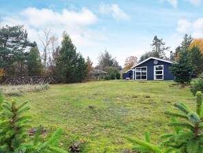 A house with a large yard, a satellite dish, and a garage.