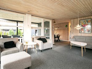 A modern interior with a sofa, armchairs, and a dining table. - 6 Person Holiday Home in Hals (Hals)