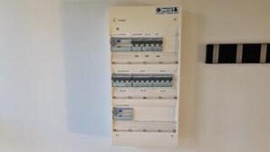 A control panel with multiple switches and indicators, likely for building management. - 5 Star Holiday Home in Lokken (Lokken)
