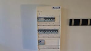 A utility panel with multiple circuit breakers and a label on the top. - 5 Star Holiday Home in Lokken (Lokken)