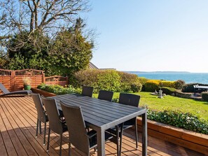 A deck with a table and chairs, overlooking a sea view. - 6 Person Holiday Home in Borkop (Borkop)