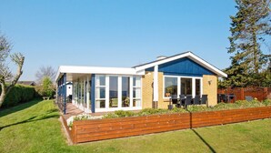 A modern house with a covered patio and a brick exterior. - 6 Person Holiday Home in Borkop (Borkop)
