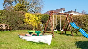 A playground with a swing set, a slide, and a boat-shaped play structure. - 6 Person Holiday Home in Borkop (Borkop)