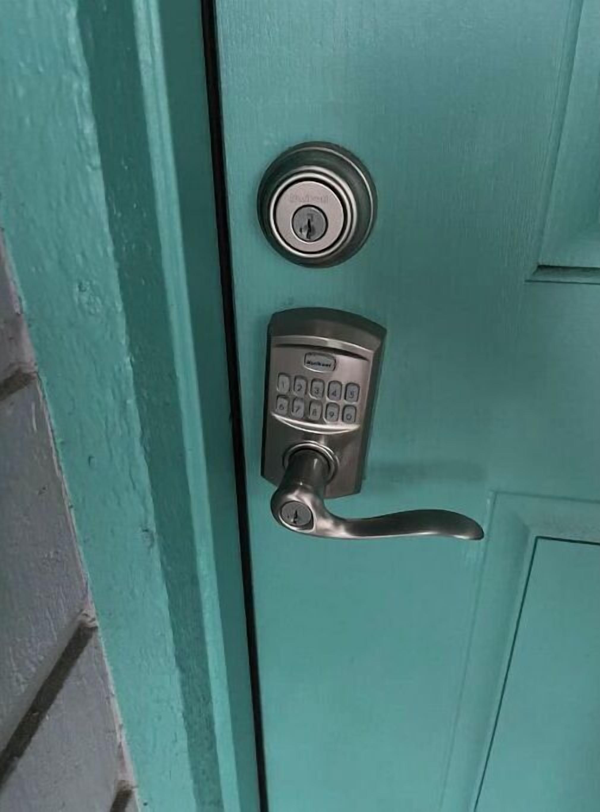 A teal door with a numeric keypad lock and a keyhole.