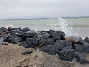 A rocky shoreline with waves crashing against the rocks. - 5 Person Holiday Home in Otterup (Otterup)