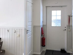 A hallway with a white door, a window, and a red fire extinguisher mounted on the wall. - 4 Star Holiday Home in Salen (Salen)