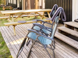 A wooden deck with a folding chair and a table. - 4 Star Holiday Home in Salen (Salen)