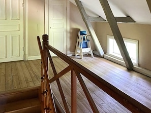 A room with a wooden staircase, white doors, and a window with a view of the outside. - 4 Star Holiday Home in Sandhem (Sandhem)